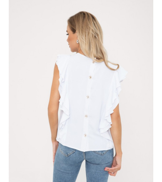 Біла блузка з рюшами і гудзиками на спинці