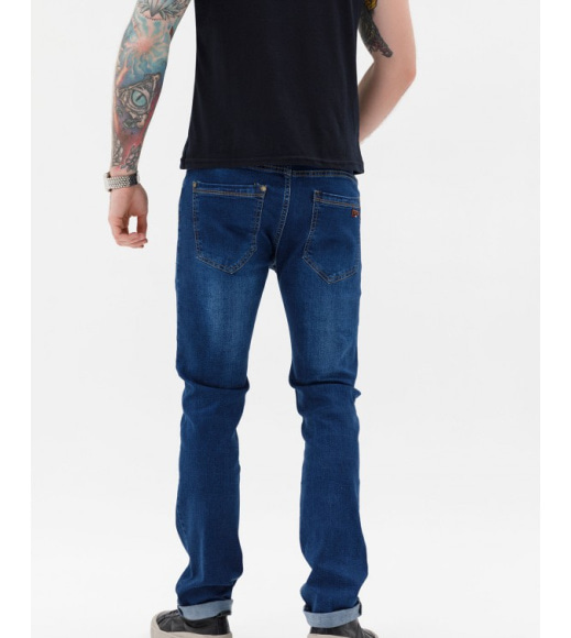 Синие потертые джинсы классического кроя