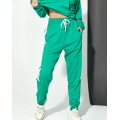 Зелені трикотажні штани з тасьми
