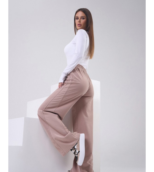 Бежевые трикотажные штаны с боковыми вставками